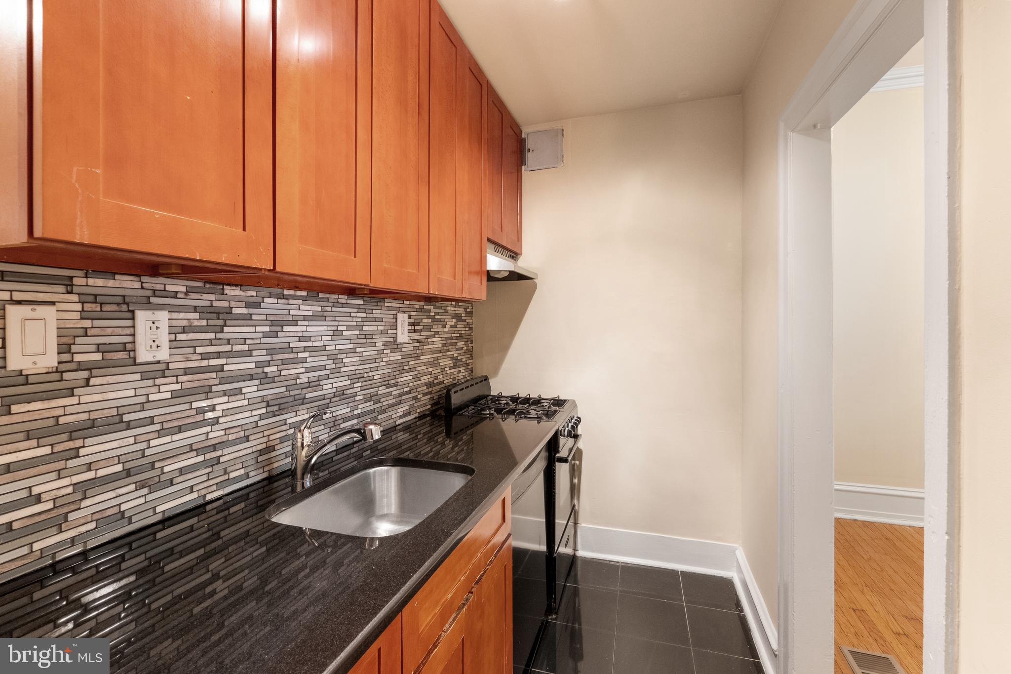 2433 Fairmount Avenue, Unit 1 Philadelphia, PA 19130 - Photo 5 of 13 a bathroom with a sink and cabinets