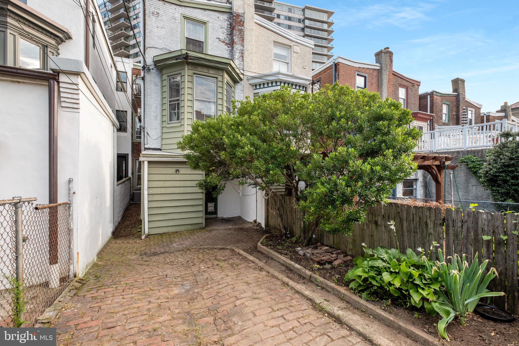 2433 Fairmount Avenue, Unit 1 Philadelphia, PA 19130 - Photo 10 of 13 a yellow building with trees in front of it