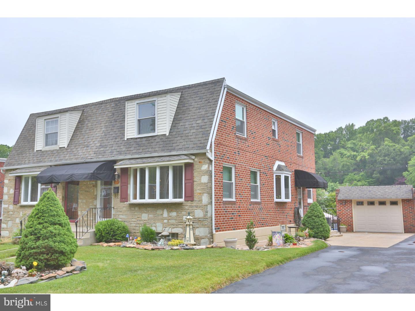 8610 Bridle Road Philadelphia, PA 19115 - Photo 1 of 25 a front view of a house with a yard and garage
