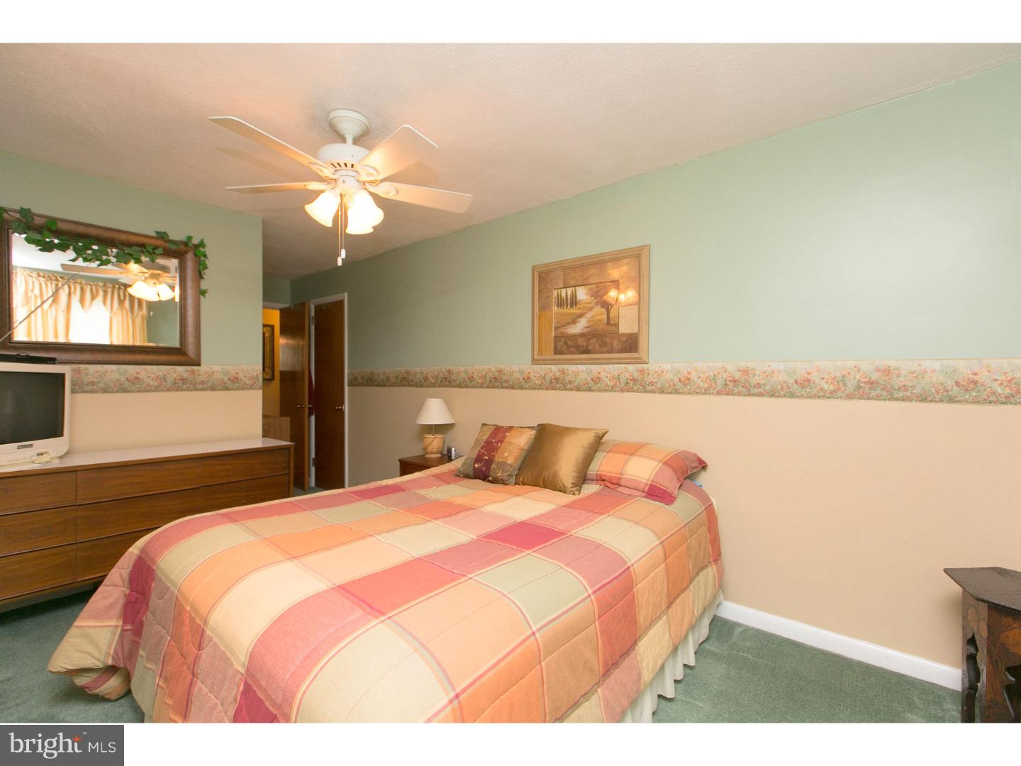 8610 Bridle Road Philadelphia, PA 19115 - Photo 17 of 25 a bedroom with a bed and a chandelier