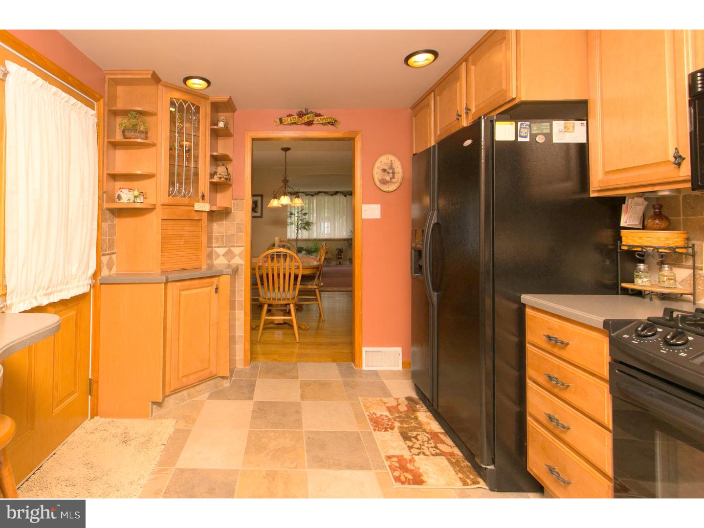 8610 Bridle Road Philadelphia, PA 19115 - Photo 4 of 25 a kitchen with stainless steel appliances kitchen island granite countertop a refrigerator and a cabinets