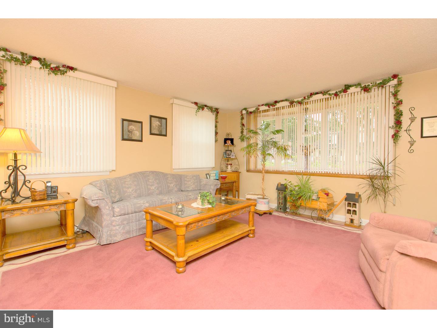 8610 Bridle Road Philadelphia, PA 19115 - Photo 9 of 25 a living room with furniture and a floor to ceiling window