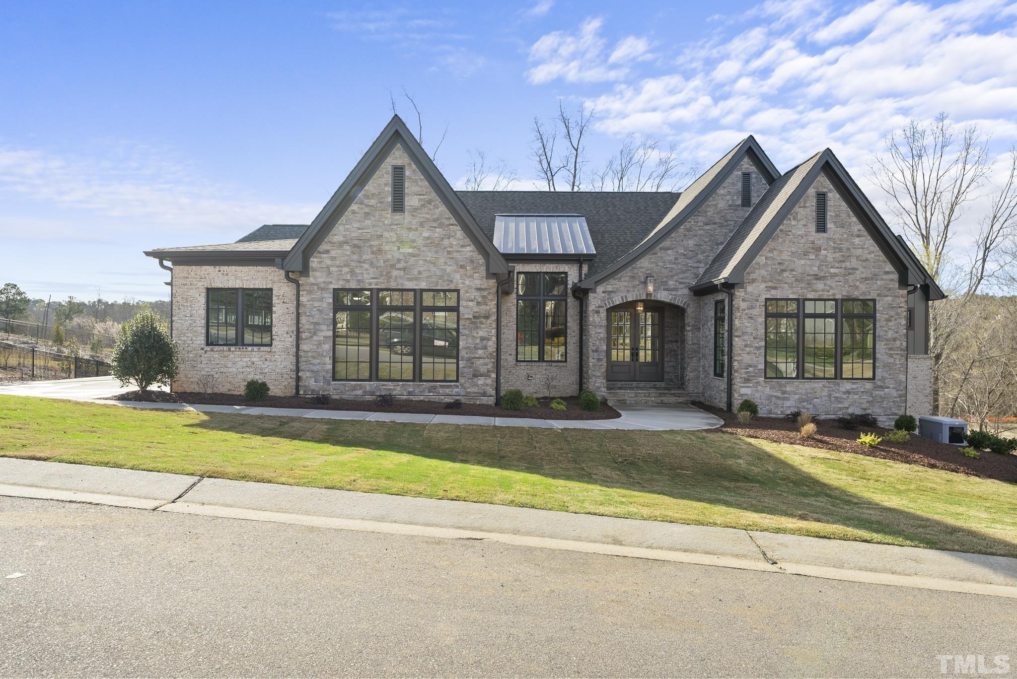 a view of a house with a swimming pool and a yard