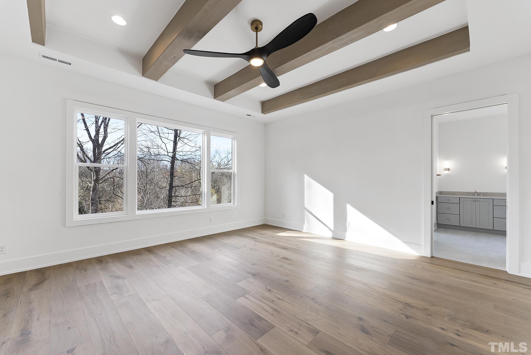 4910 Poyner Road Raleigh, NC 27612 - Photo 11 of 48 a view of an empty room with wooden floor and a window