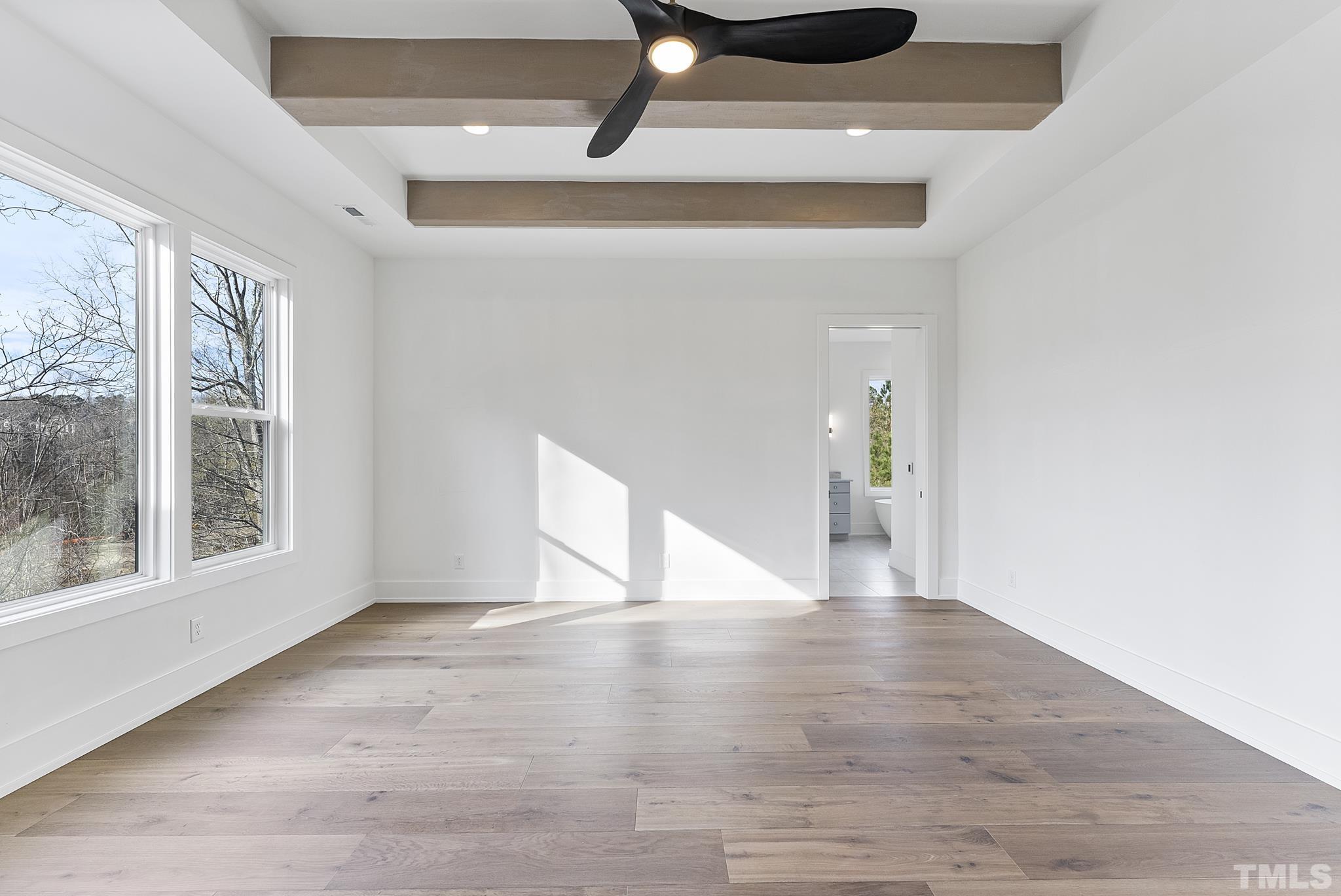 4910 Poyner Road Raleigh, NC 27612 - Photo 12 of 48 a view of an empty room with wooden floor and a window