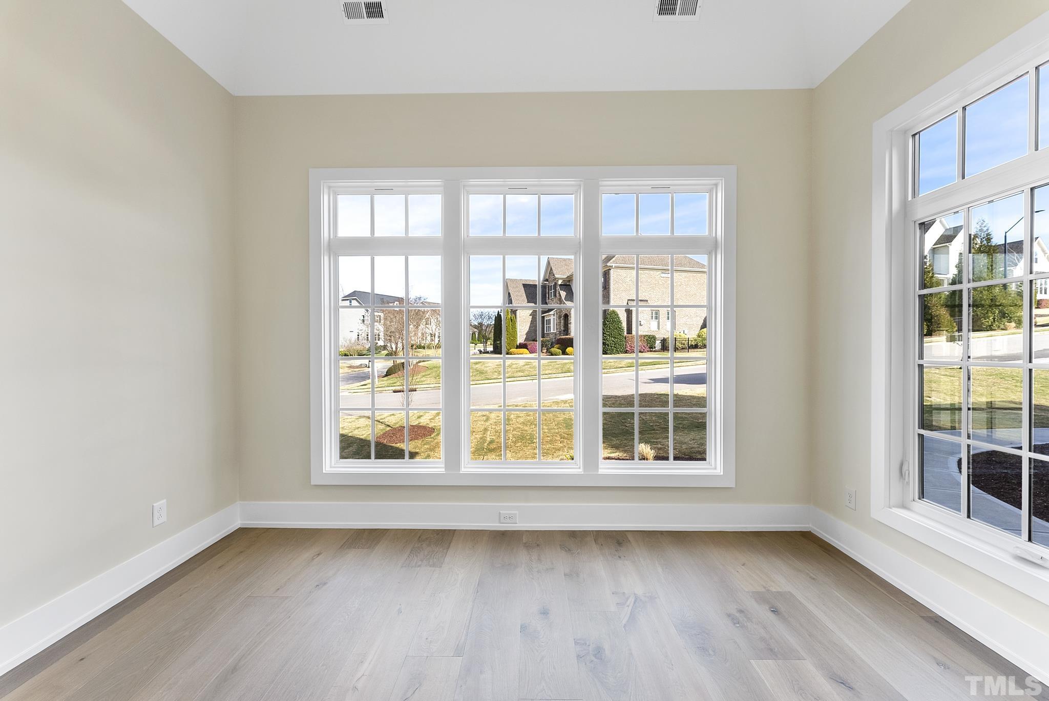 4910 Poyner Road Raleigh, NC 27612 - Photo 18 of 48 a view of an empty room with wooden floor and a window