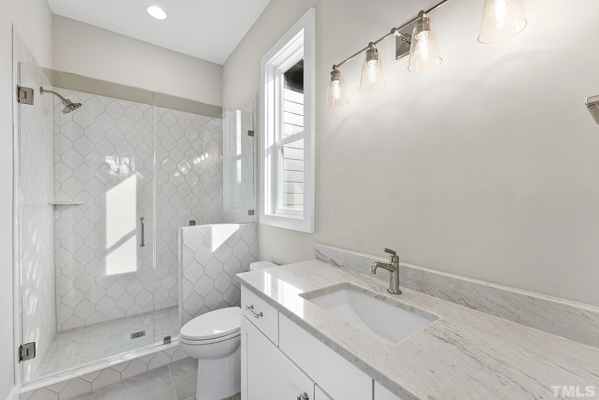 4910 Poyner Road Raleigh, NC 27612 - Photo 22 of 48 a bathroom with a granite countertop sink toilet and shower