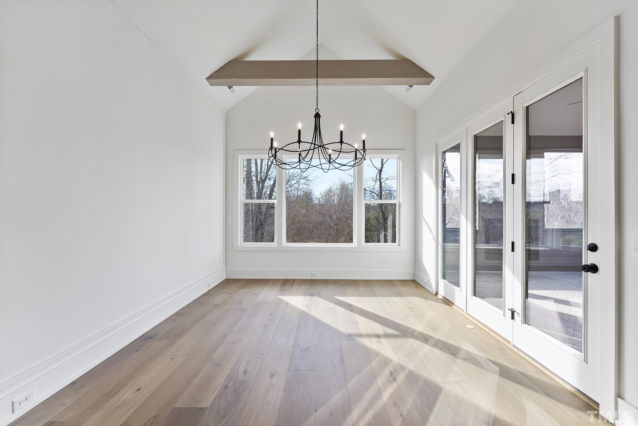 4910 Poyner Road Raleigh, NC 27612 - Photo 23 of 48 a view of an empty room with kitchen and a window