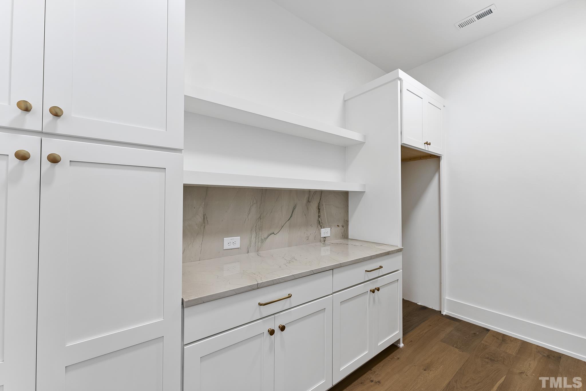 4910 Poyner Road Raleigh, NC 27612 - Photo 26 of 48 a bathroom with a granite countertop sink and white cabinets