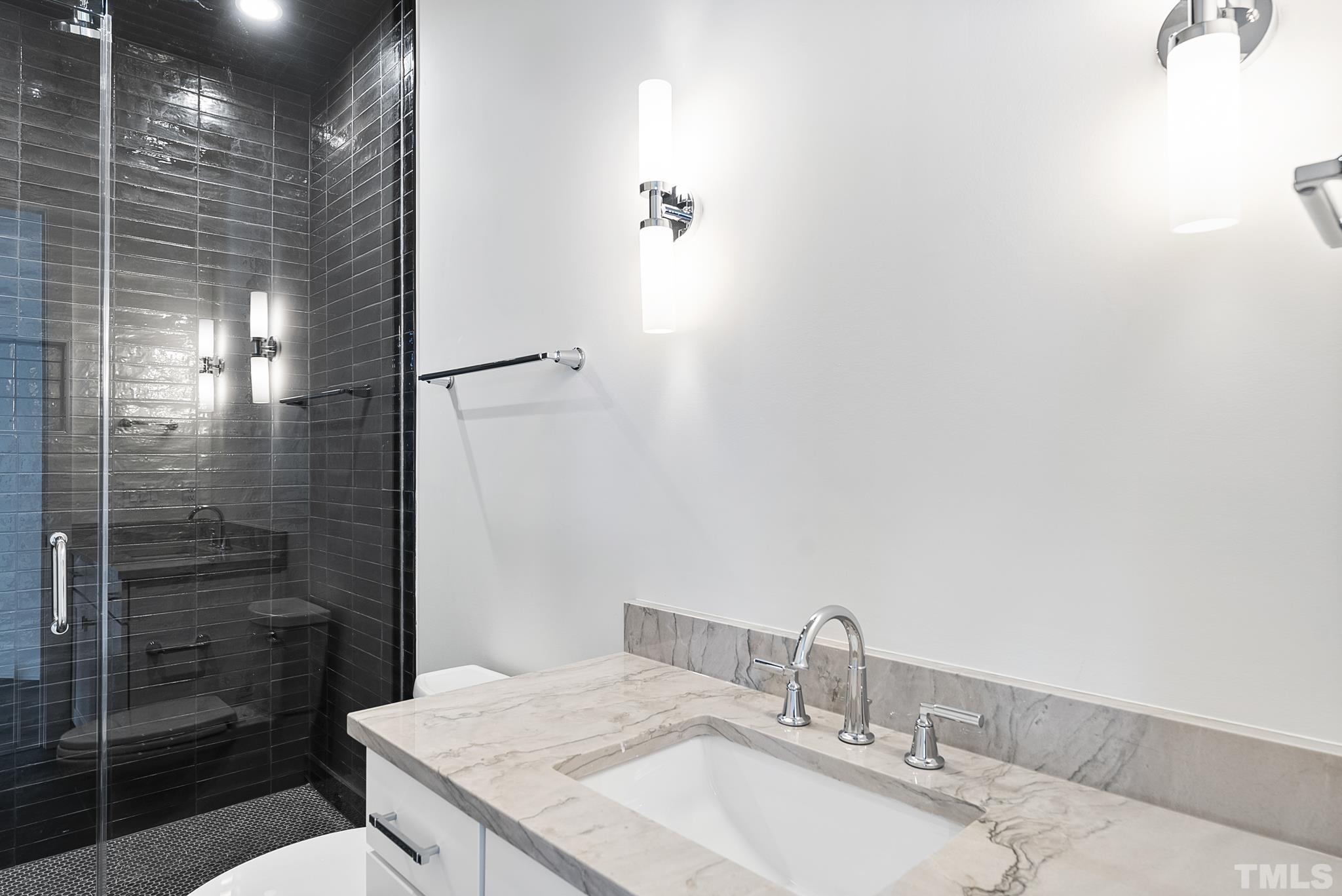 4910 Poyner Road Raleigh, NC 27612 - Photo 32 of 48 a bathroom with a granite countertop sink a toilet and shower