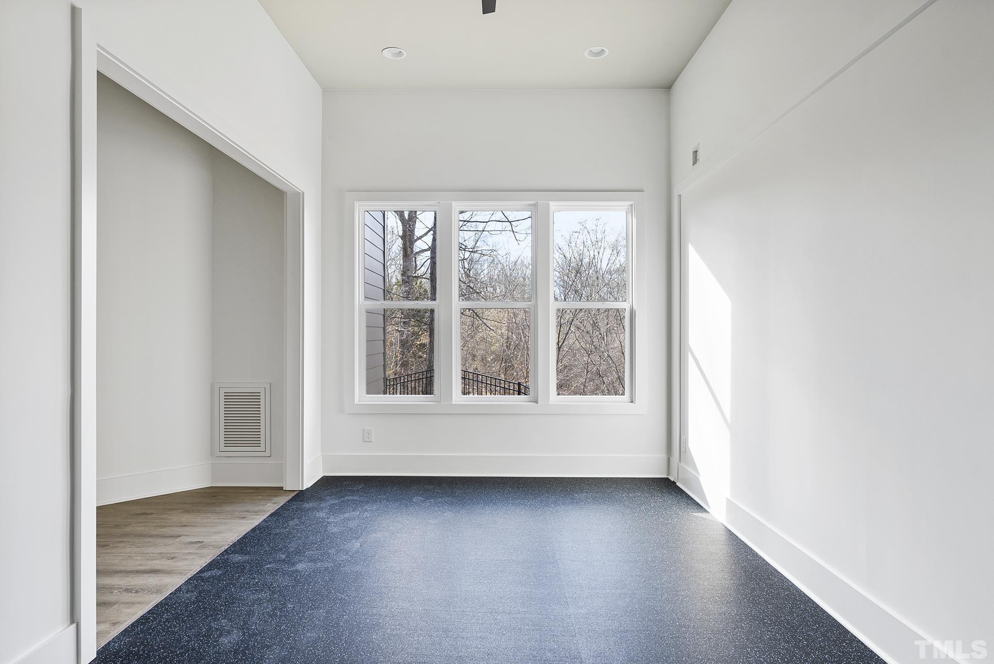 4910 Poyner Road Raleigh, NC 27612 - Photo 34 of 48 an empty room with wooden floor and windows
