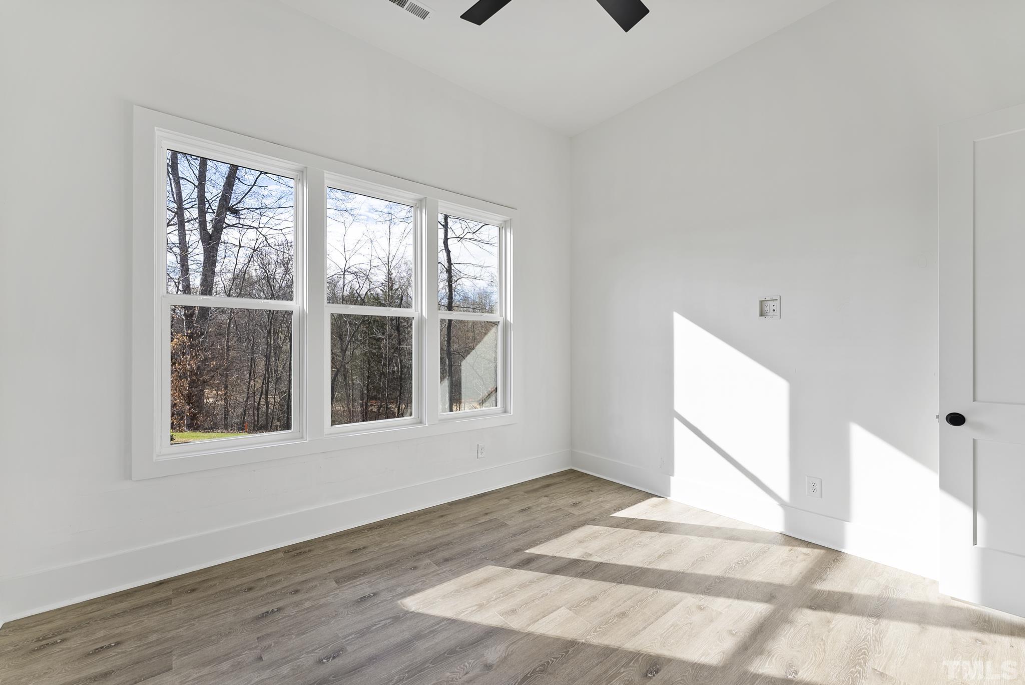 4910 Poyner Road Raleigh, NC 27612 - Photo 38 of 48 a view of an empty room with a window and wooden floor