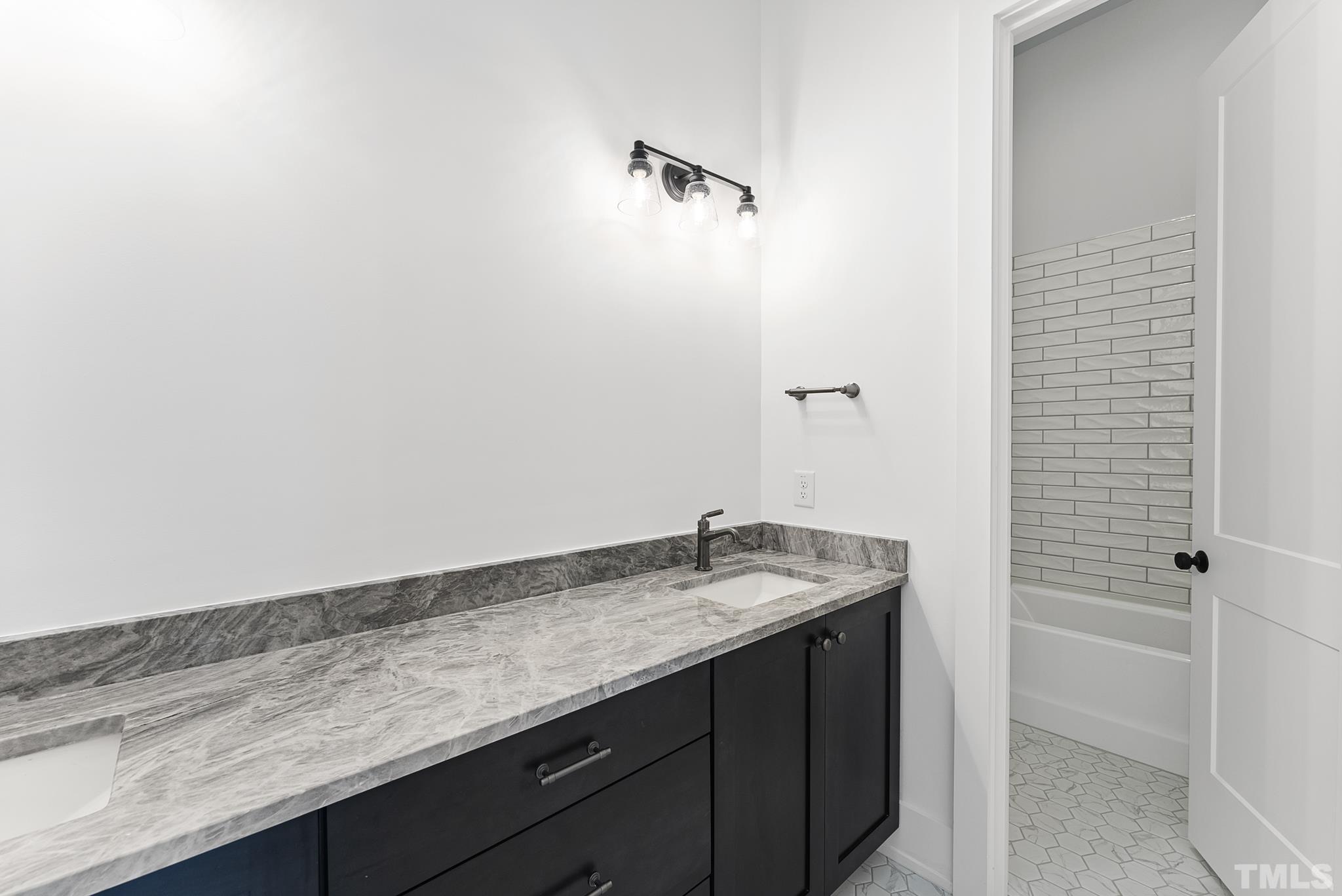 4910 Poyner Road Raleigh, NC 27612 - Photo 39 of 48 a bathroom with a granite countertop sink and a mirror