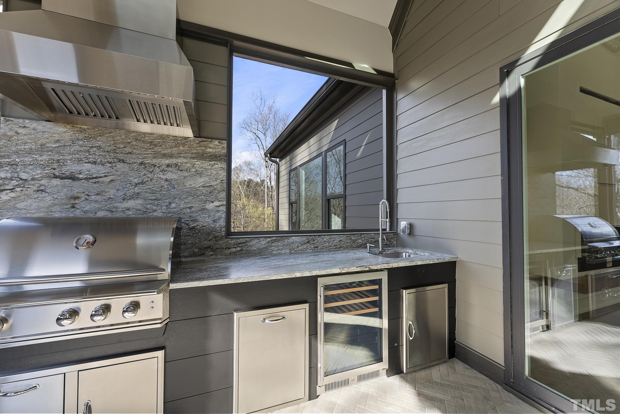 4910 Poyner Road Raleigh, NC 27612 - Photo 46 of 48 a kitchen with granite countertop a stove and a sink