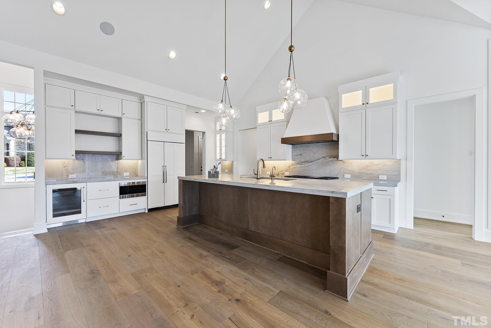 4910 Poyner Road Raleigh, NC 27612 - Photo 7 of 48 a kitchen with stainless steel appliances granite countertop a stove a sink and a refrigerator