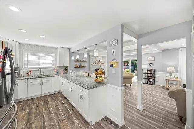 a kitchen with sink cabinets and wooden floor