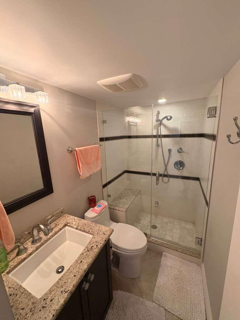 2611 North Riverside Drive, Unit 703 Pompano Beach, FL 33062 - Photo 51 of 81 a bathroom with a sink toilet and shower