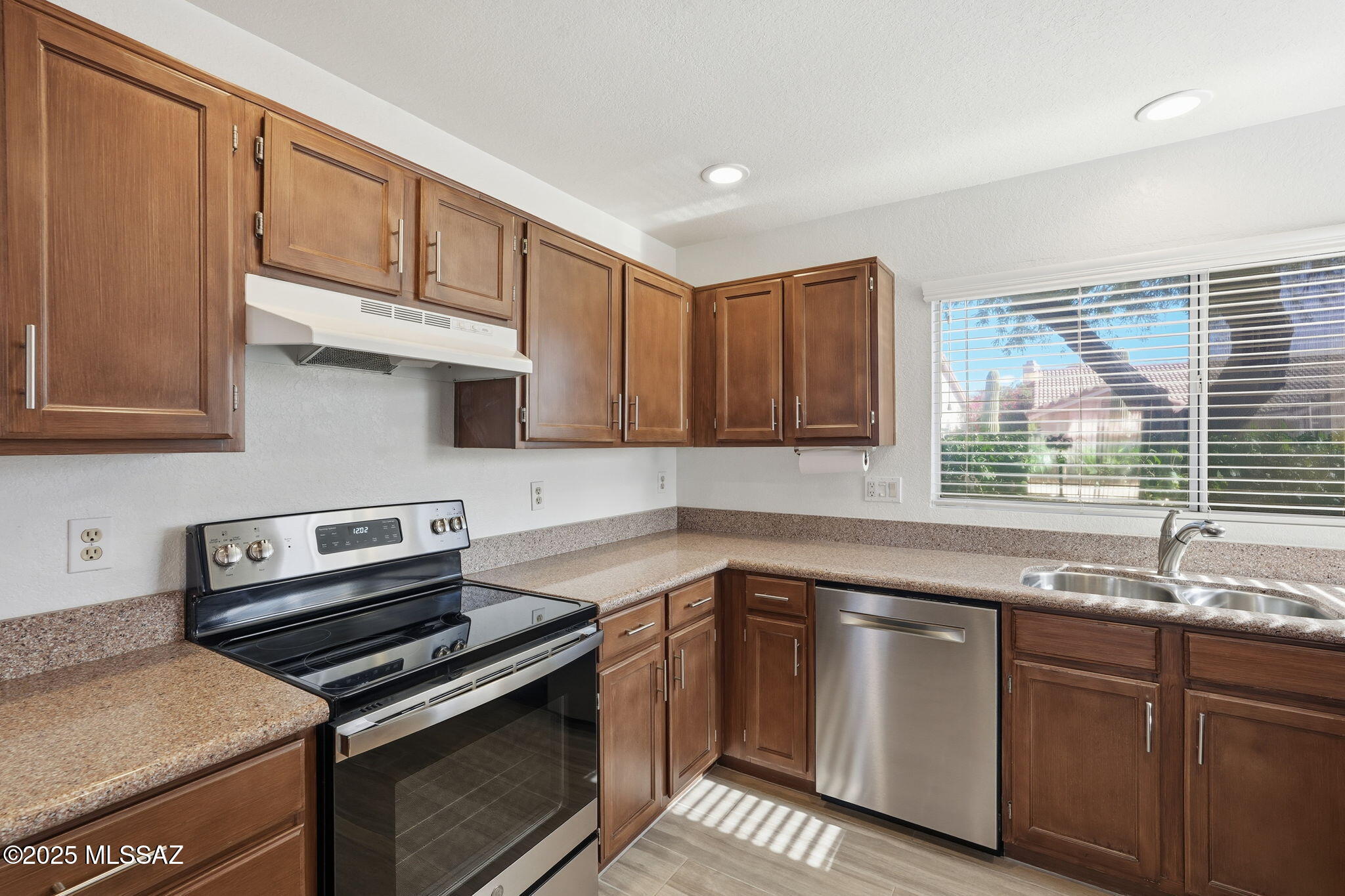 3592 West Sky Ridge Loop Tucson, AZ 85742 - Photo 10 of 41 a kitchen with stainless steel appliances granite countertop a sink stove and cabinets