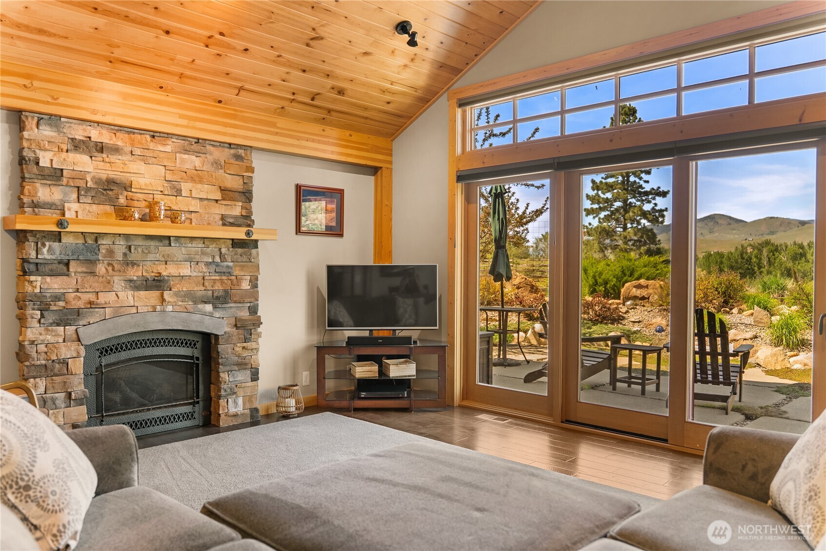 130 Sundown Road Winthrop, WA 98862 - Photo 10 of 40 a living room with furniture a flat screen tv and a fireplace