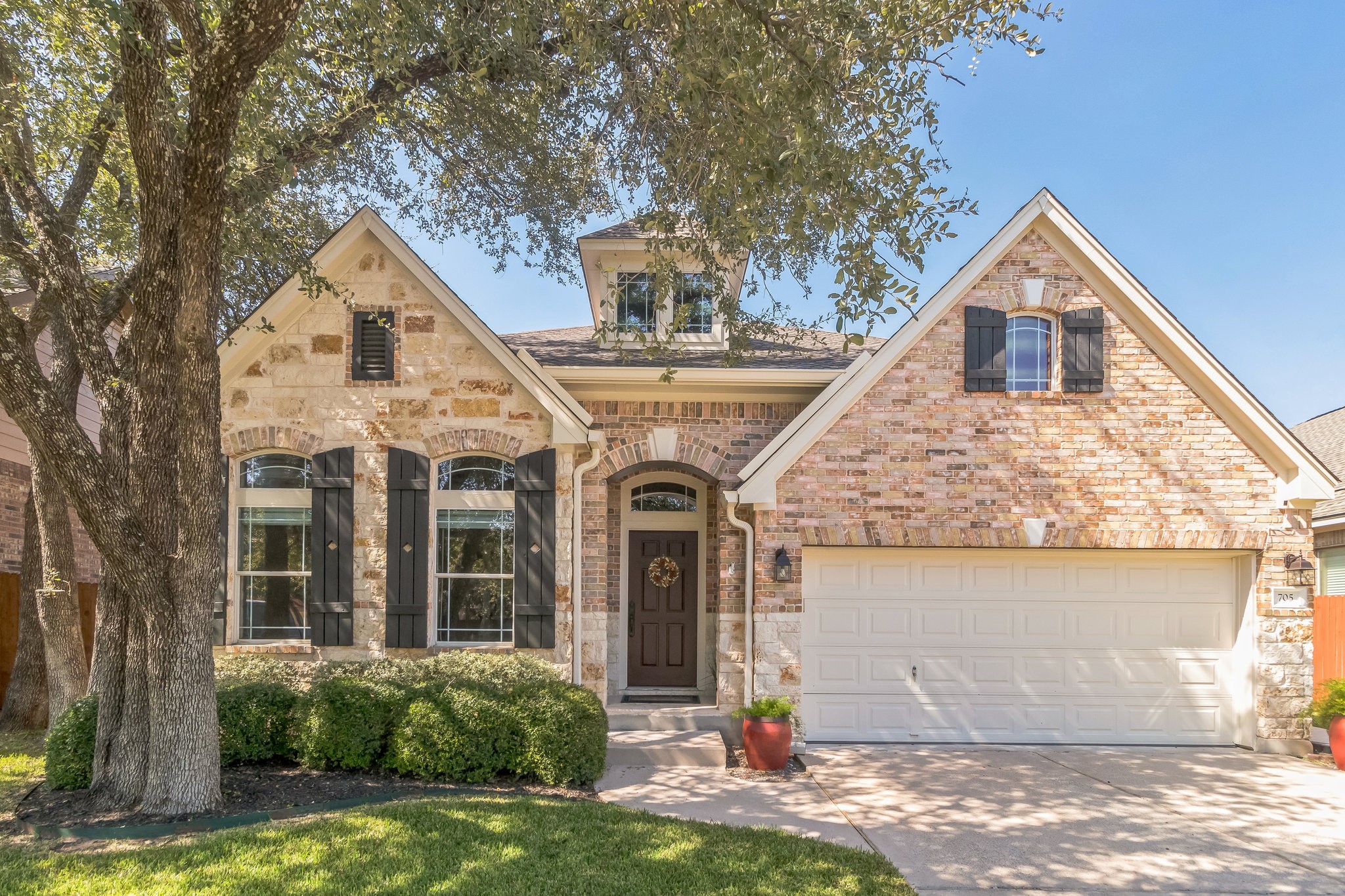 a front view of a house with garden