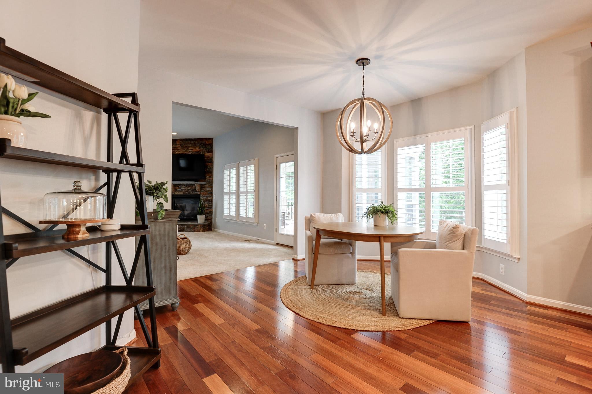 23372 Minerva Drive Brambleton, VA 20148 - Photo 11 of 61 a view of a dining room with furniture window and wooden floor