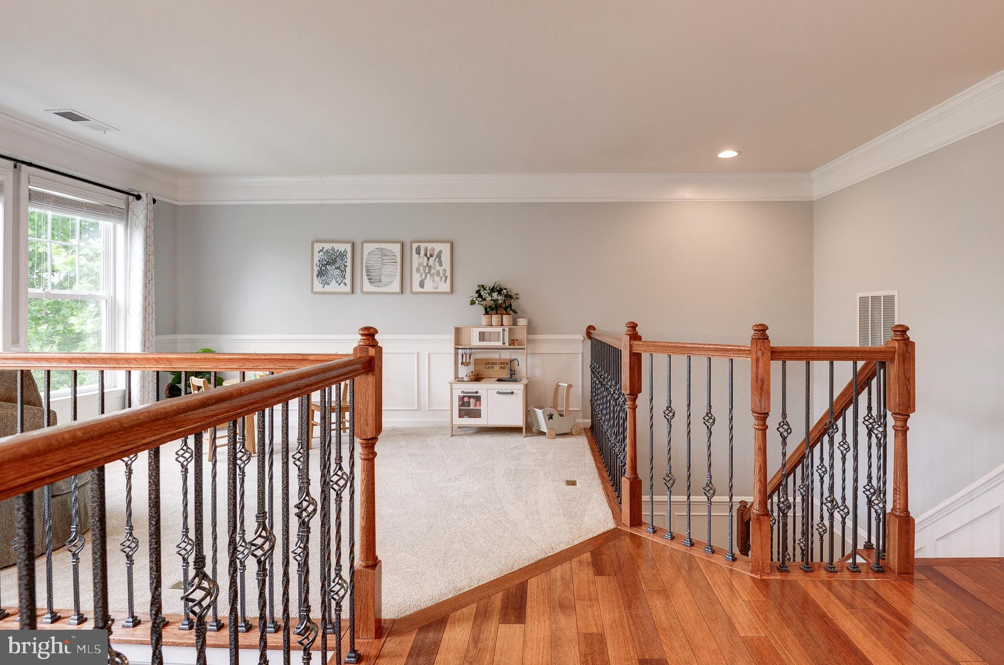 23372 Minerva Drive Brambleton, VA 20148 - Photo 27 of 61 a view of a hallway with wooden floor and stairs