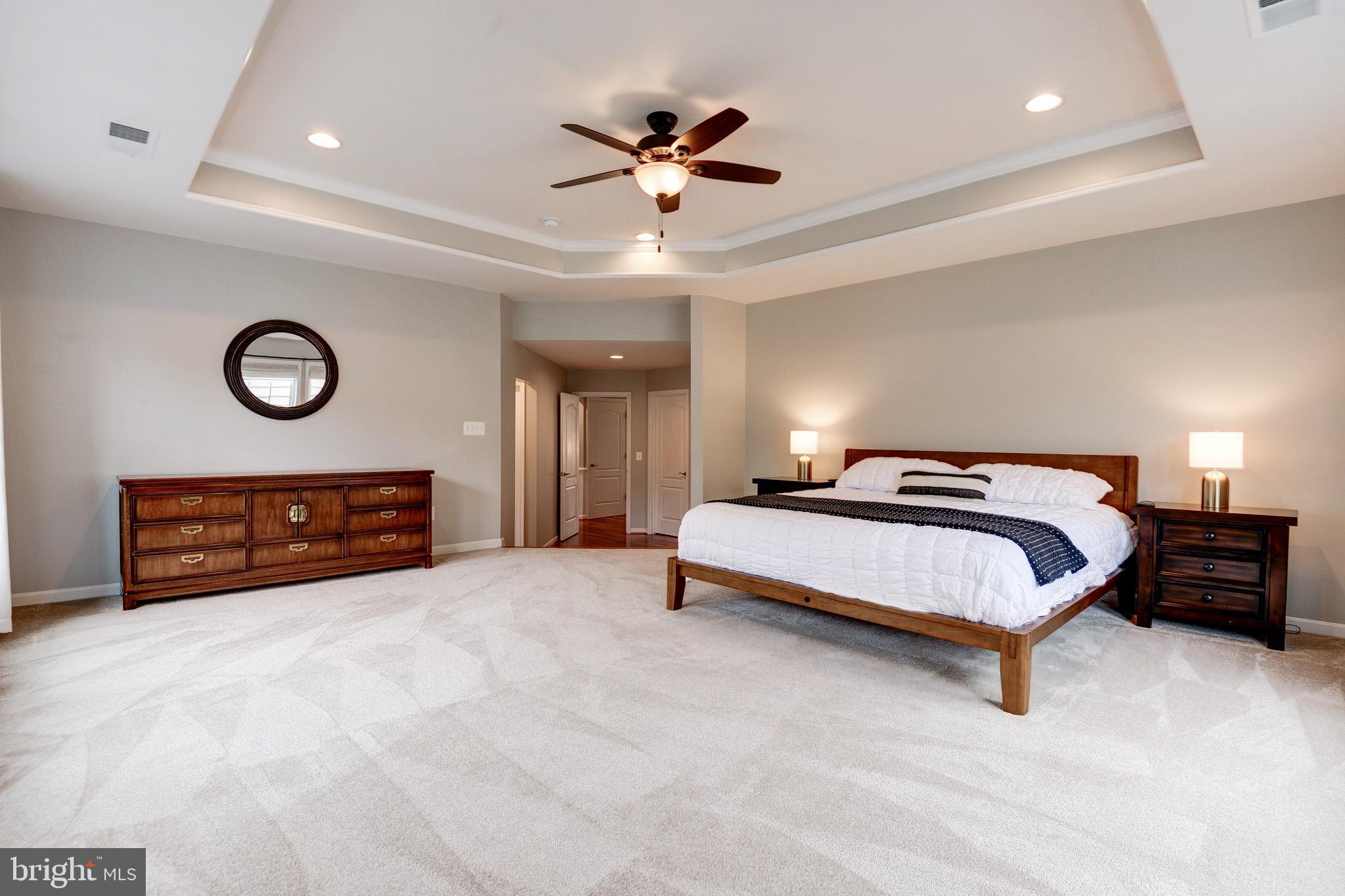 23372 Minerva Drive Brambleton, VA 20148 - Photo 28 of 61 a spacious bedroom with a bed and a ceiling fan