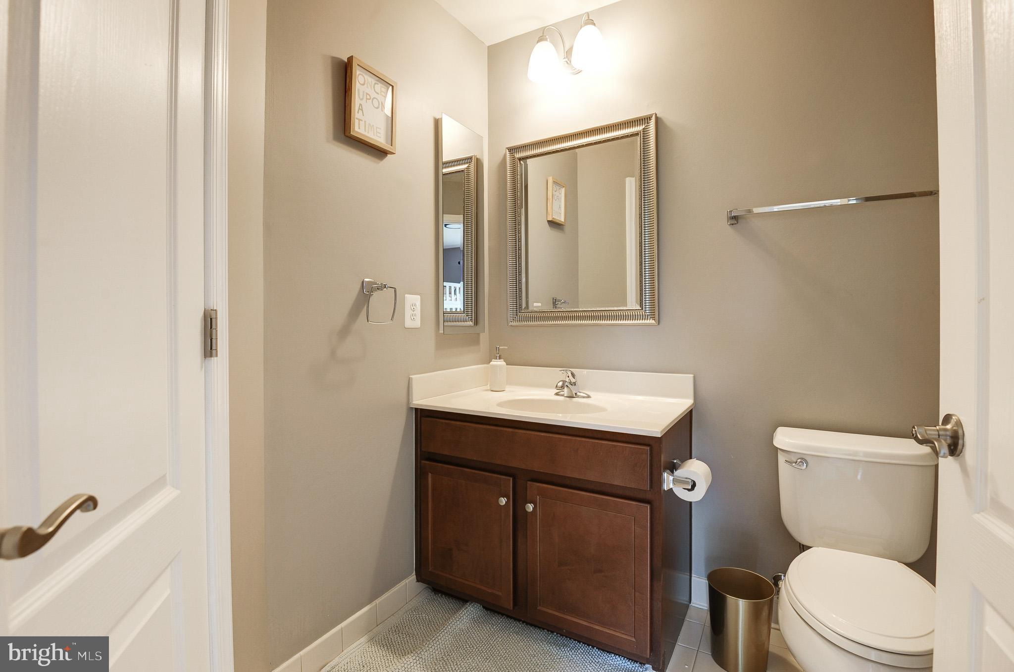 23372 Minerva Drive Brambleton, VA 20148 - Photo 36 of 61 a bathroom with a toilet a sink and mirror