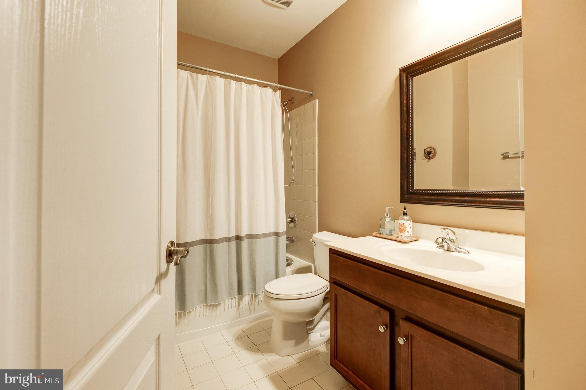 23372 Minerva Drive Brambleton, VA 20148 - Photo 44 of 61 a bathroom with a sink a toilet and a mirror