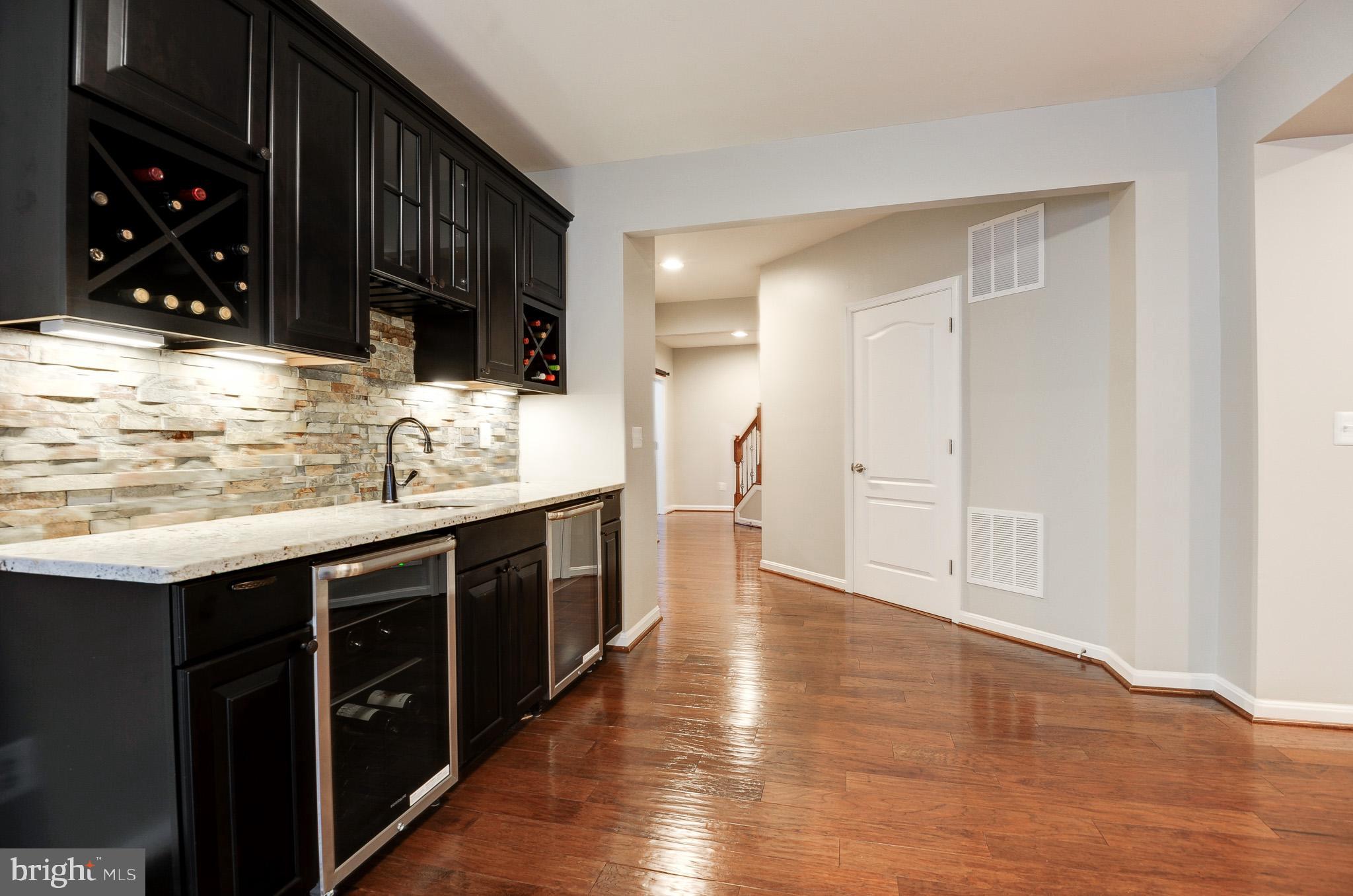 23372 Minerva Drive Brambleton, VA 20148 - Photo 48 of 61 a kitchen with stainless steel appliances granite countertop a stove and cabinets