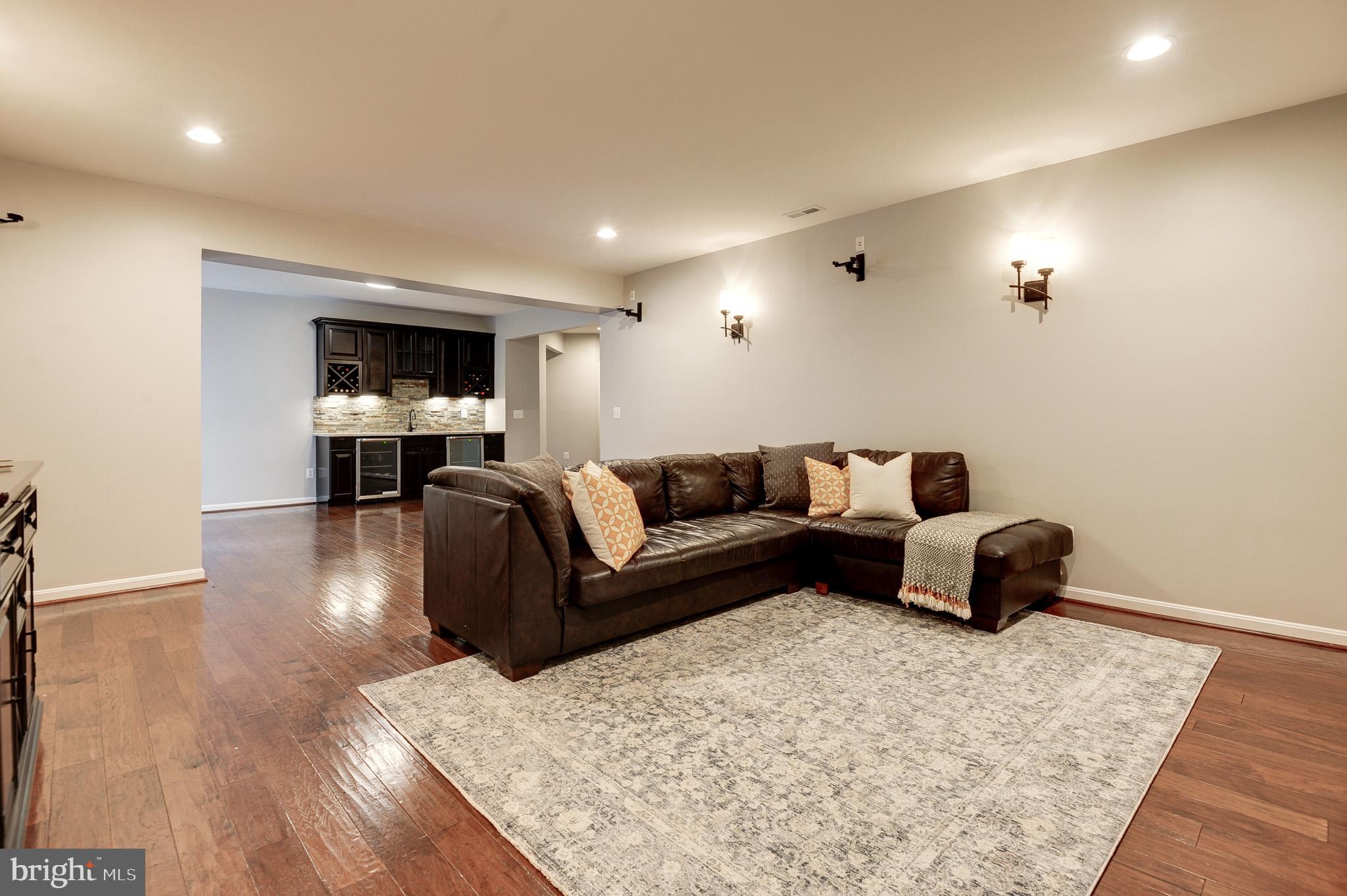 23372 Minerva Drive Brambleton, VA 20148 - Photo 50 of 61 a living room with furniture and a flat screen tv