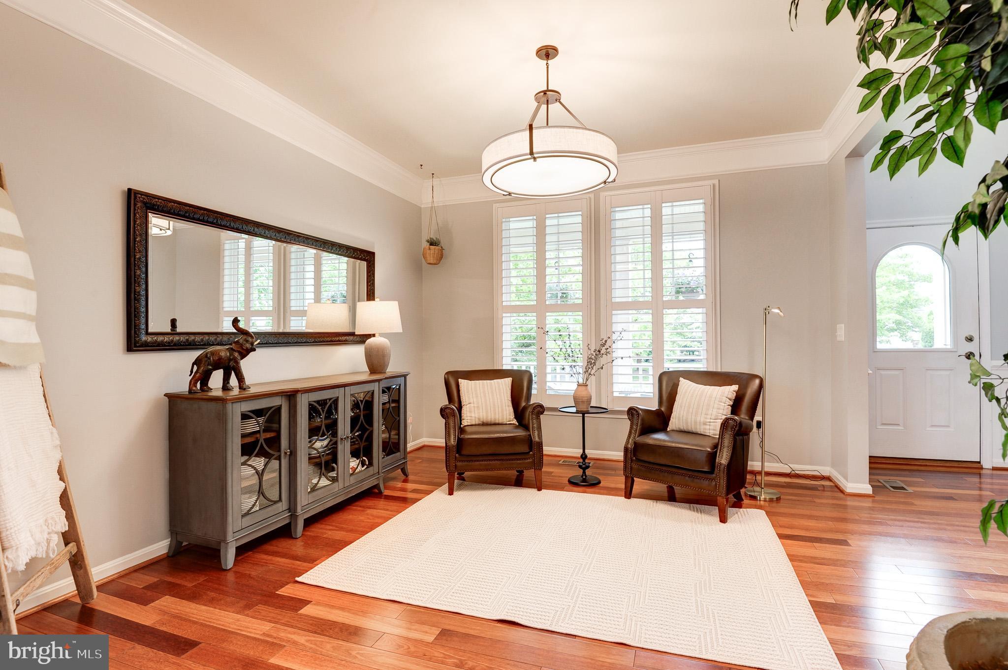 23372 Minerva Drive Brambleton, VA 20148 - Photo 7 of 61 a living room with furniture and a chandelier