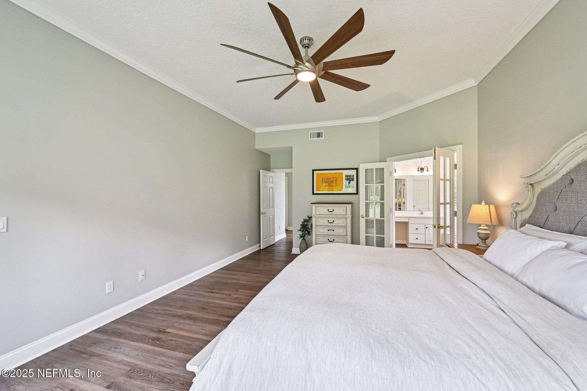 2300 Spring Hill Court Fleming Island, FL 32003 - Photo 12 of 45 a spacious bedroom with a bed and ceiling fan