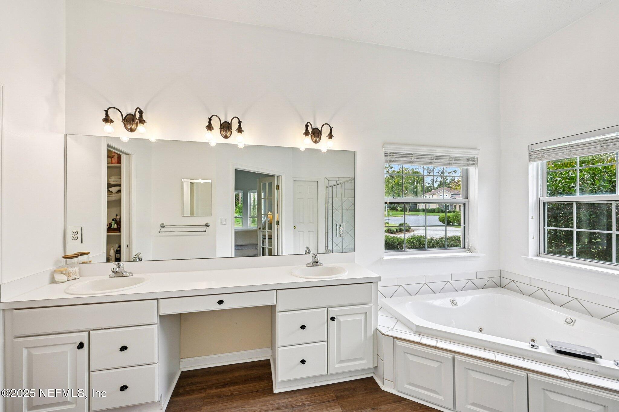 2300 Spring Hill Court Fleming Island, FL 32003 - Photo 13 of 45 a spacious bathroom with a bathtub double sink and a window