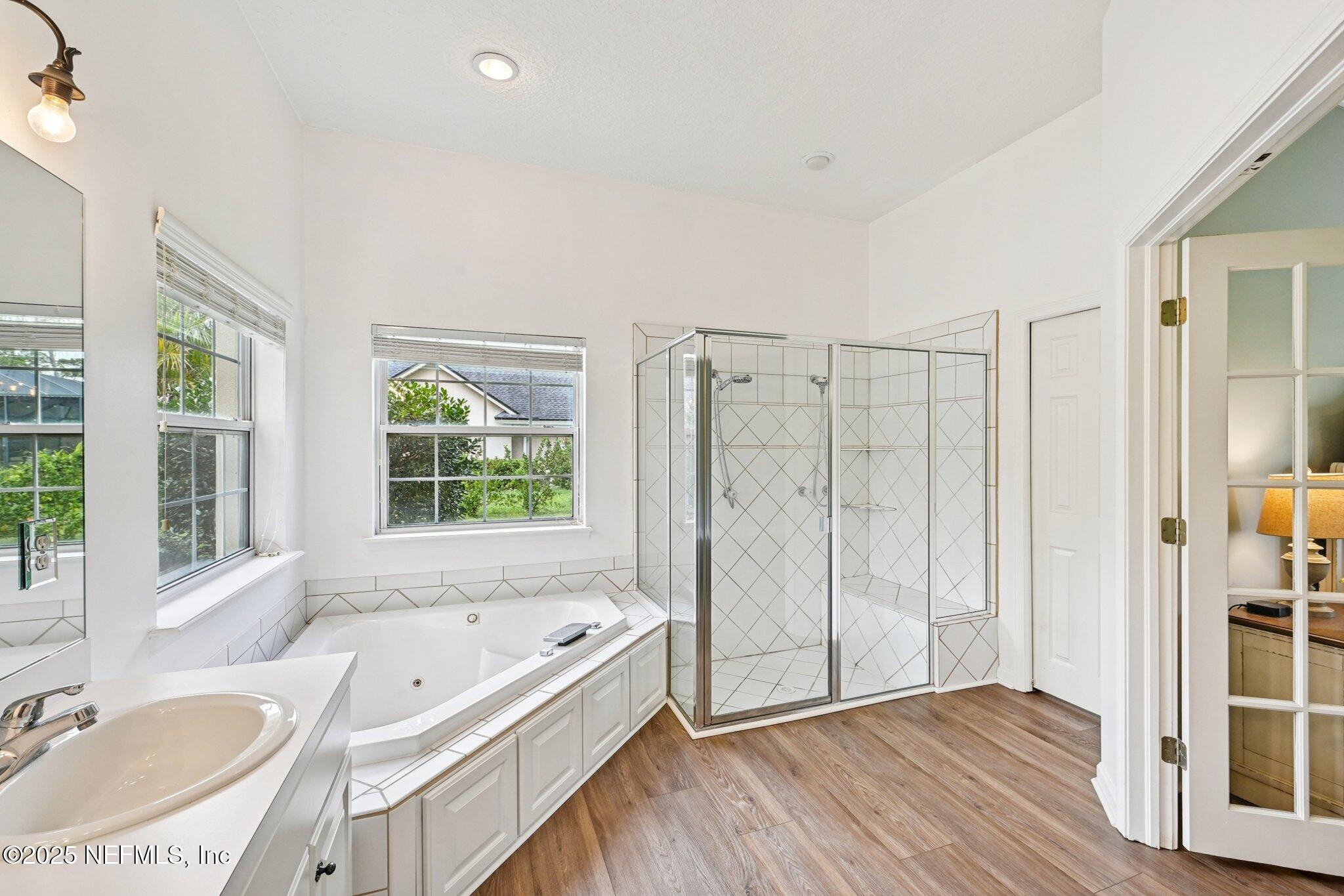 2300 Spring Hill Court Fleming Island, FL 32003 - Photo 14 of 45 a bathroom with a tub a sink and a large window