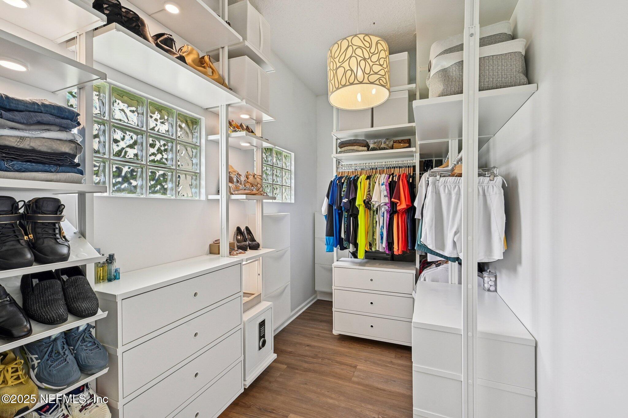 2300 Spring Hill Court Fleming Island, FL 32003 - Photo 15 of 45 a view of walk in closet with clothes and shoes