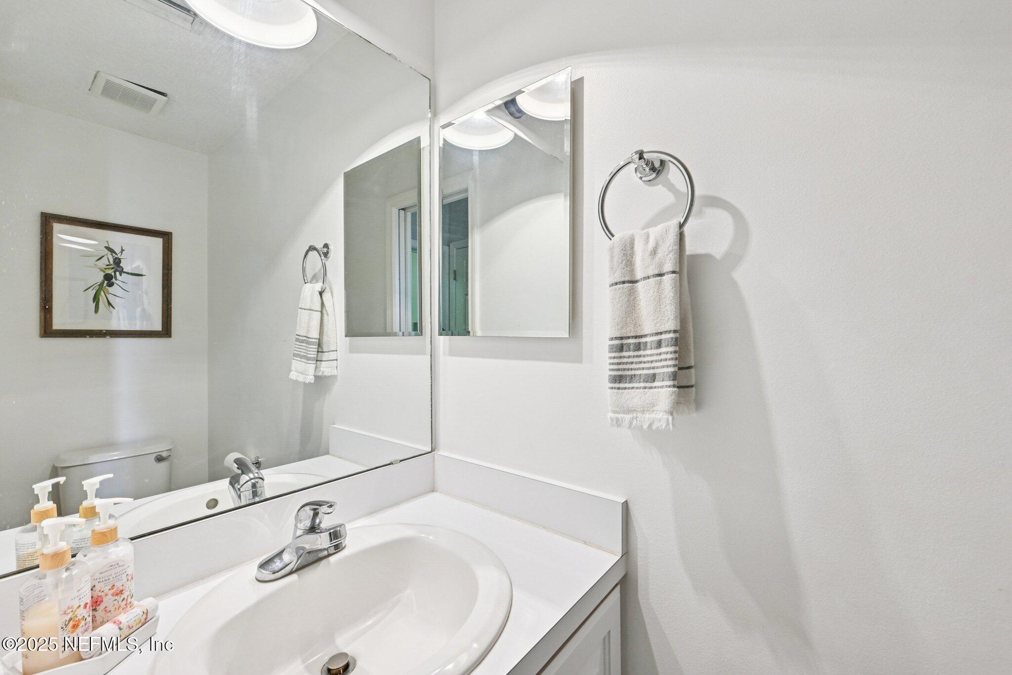 2300 Spring Hill Court Fleming Island, FL 32003 - Photo 16 of 45 a bathroom with a sink and a mirror