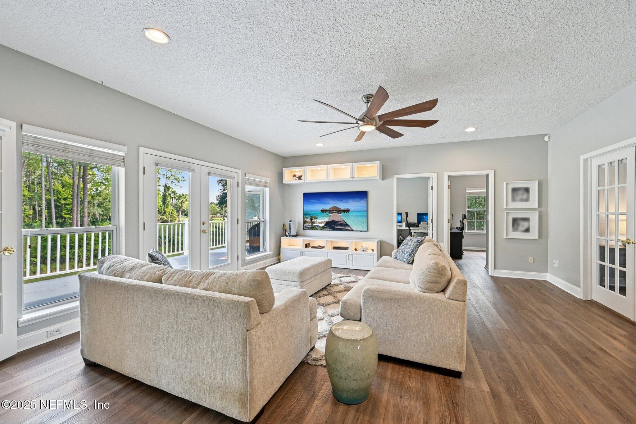 2300 Spring Hill Court Fleming Island, FL 32003 - Photo 17 of 45 a living room with furniture and a large window with wooden floor