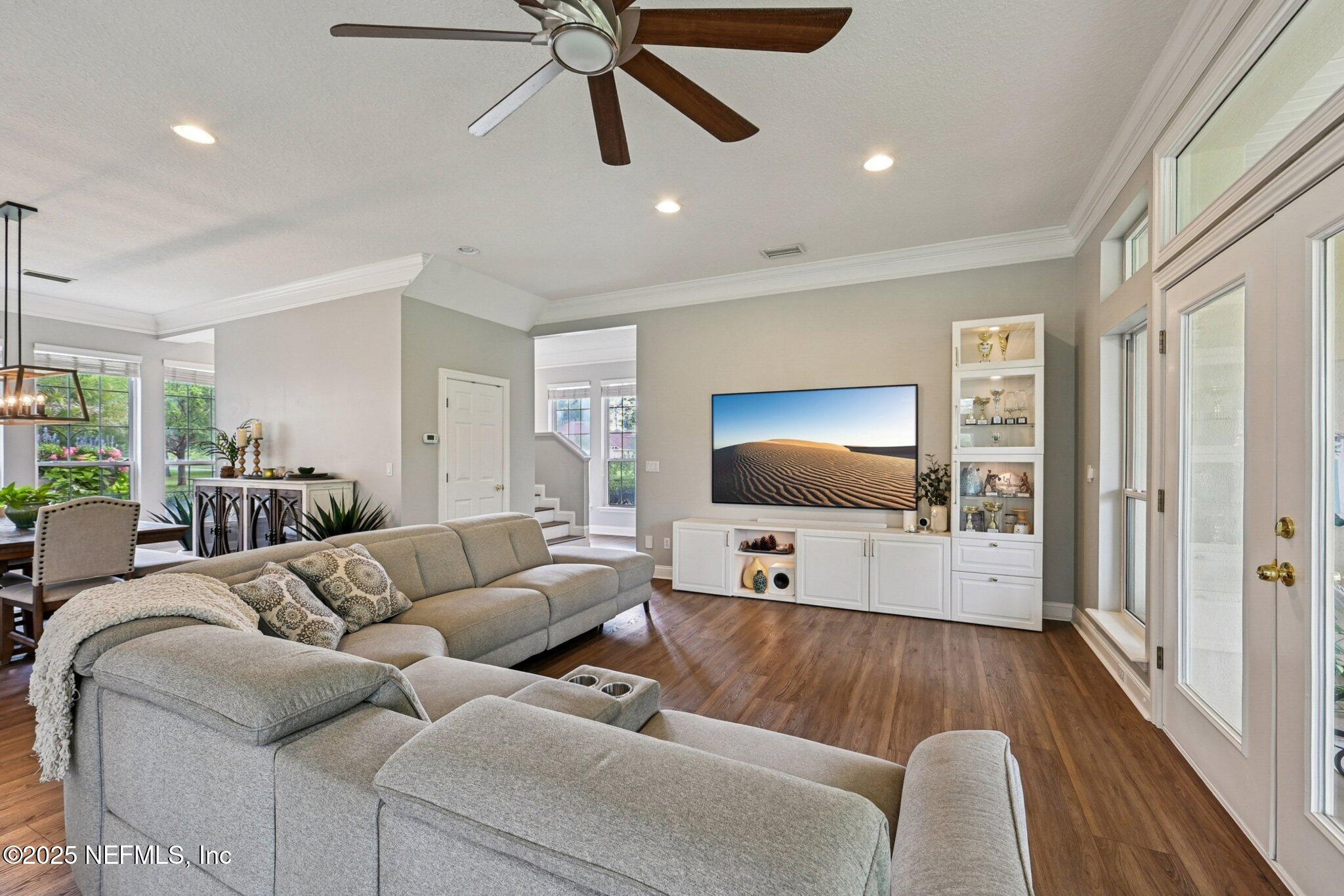 2300 Spring Hill Court Fleming Island, FL 32003 - Photo 2 of 45 a living room with furniture and a flat screen tv