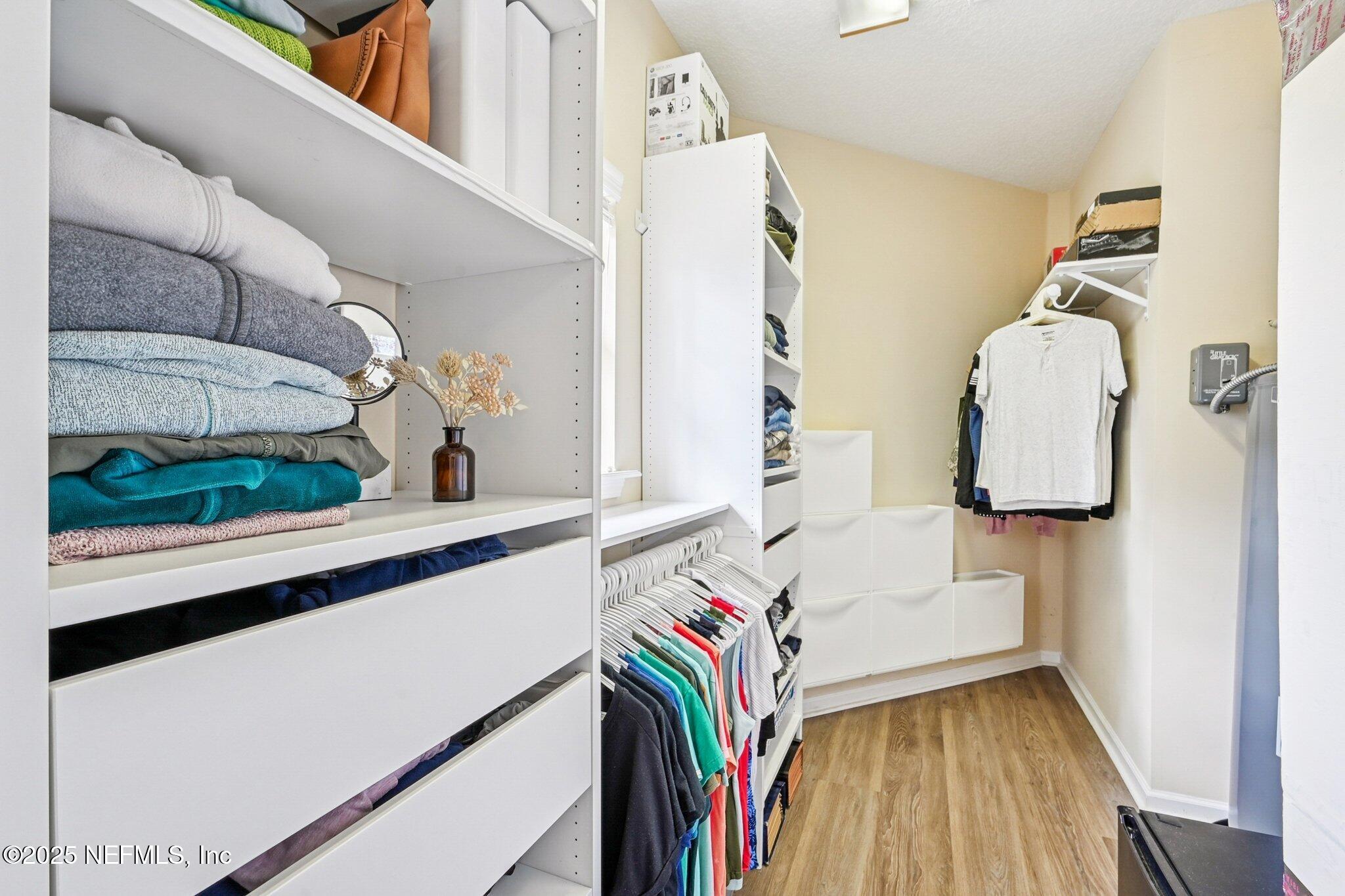 2300 Spring Hill Court Fleming Island, FL 32003 - Photo 29 of 45 a view of walk in closet with clothes and shoes