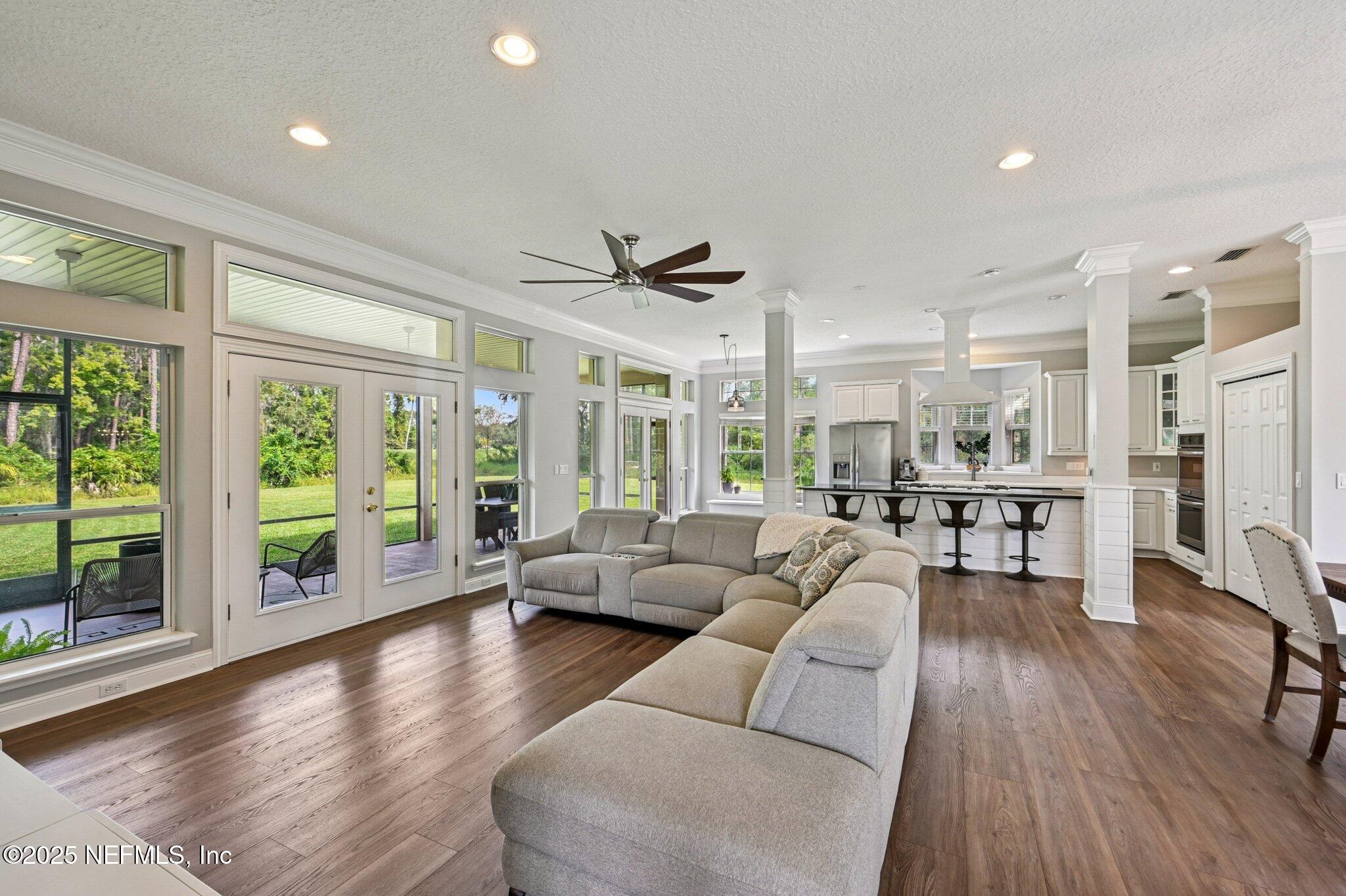 2300 Spring Hill Court Fleming Island, FL 32003 - Photo 3 of 45 a living room with furniture large windows and wooden floor