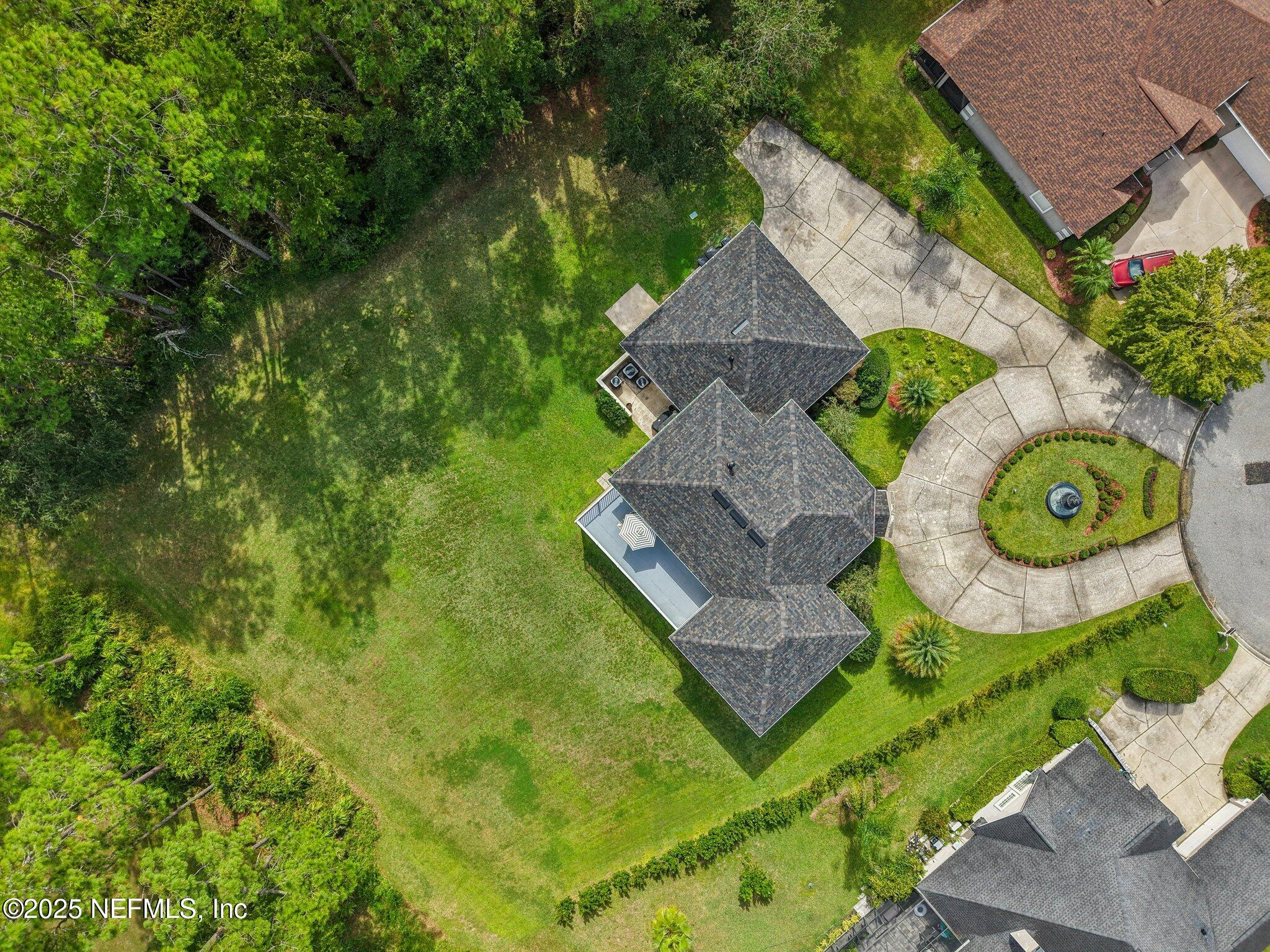 2300 Spring Hill Court Fleming Island, FL 32003 - Photo 36 of 45 an aerial view of a house with garden space and trees all around
