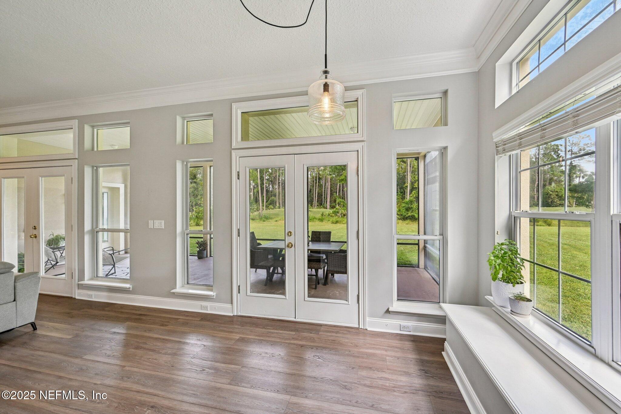 2300 Spring Hill Court Fleming Island, FL 32003 - Photo 8 of 45 a view of an entryway with wooden floor and windows