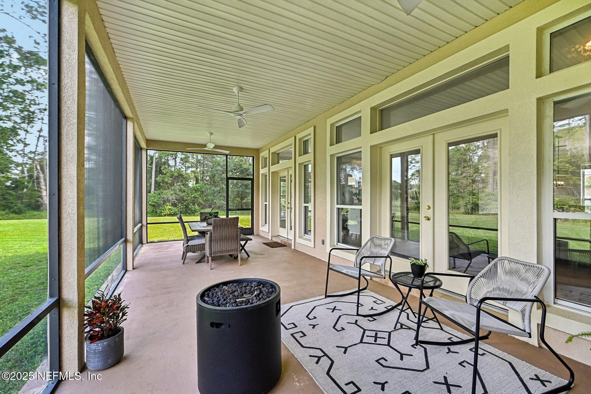 2300 Spring Hill Court Fleming Island, FL 32003 - Photo 9 of 45 a living room with patio furniture and a floor to ceiling window