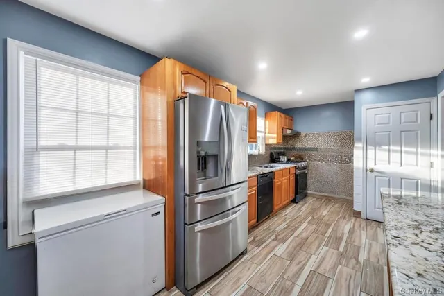 a front view of house with a garden and deck