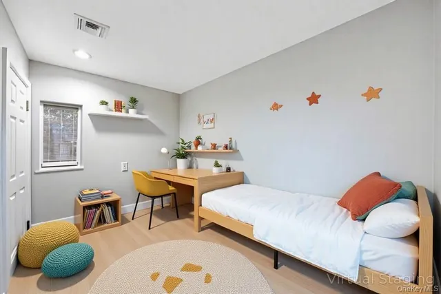 a bedroom with a bed and a mirror