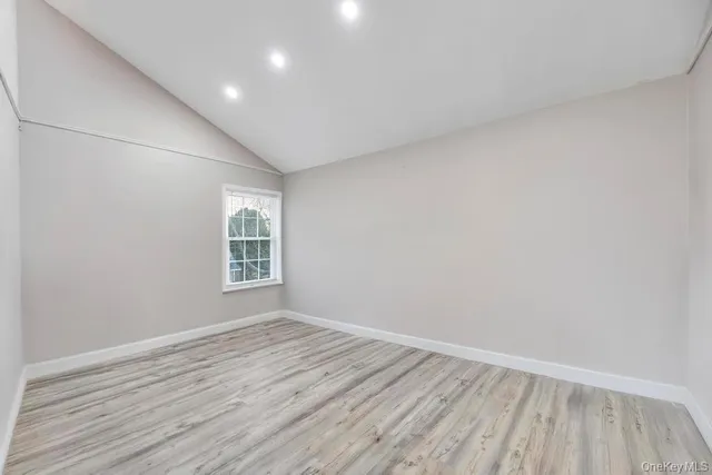 a bedroom with bed and a chair