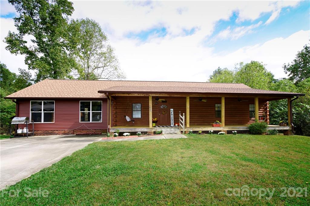 a front view of a house with a yard and trees