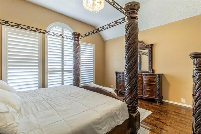 a bedroom with a bed and a chandelier