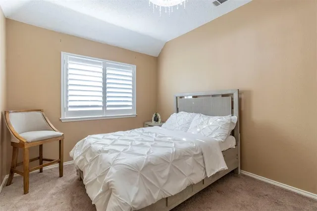 a bedroom with a bed and a chair